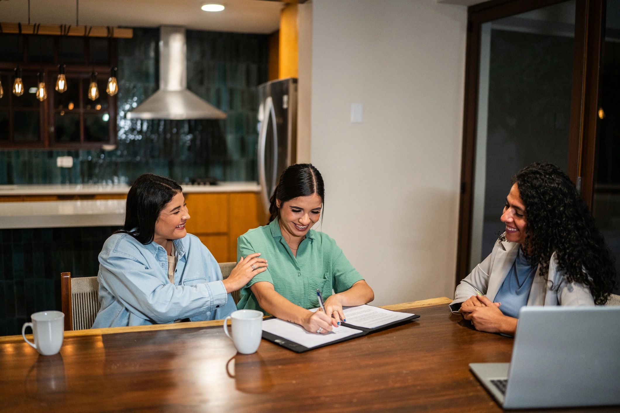 Clients reviewing and signing documents at a closing meeting