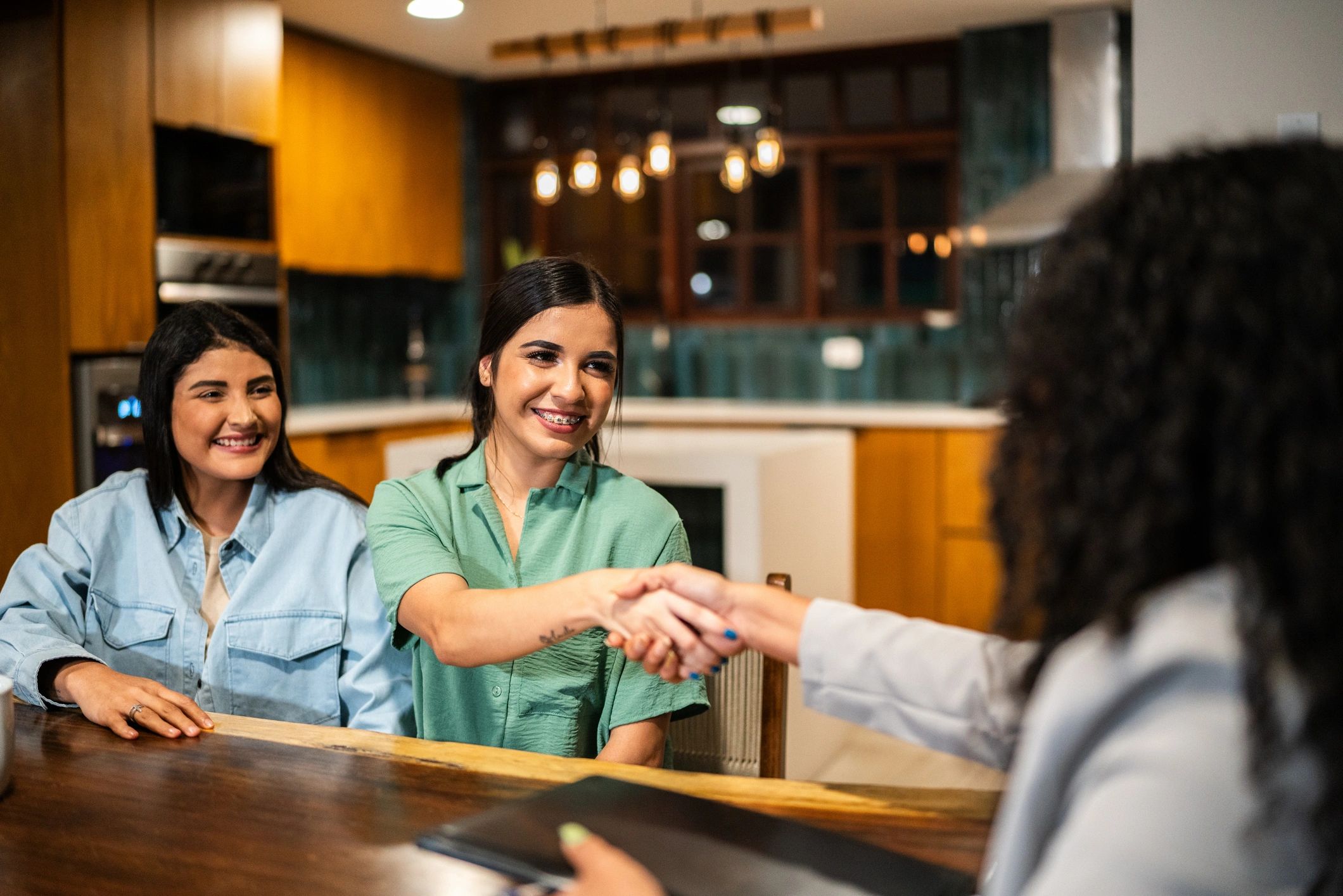 Handshake after a successful real estate closing meeting
