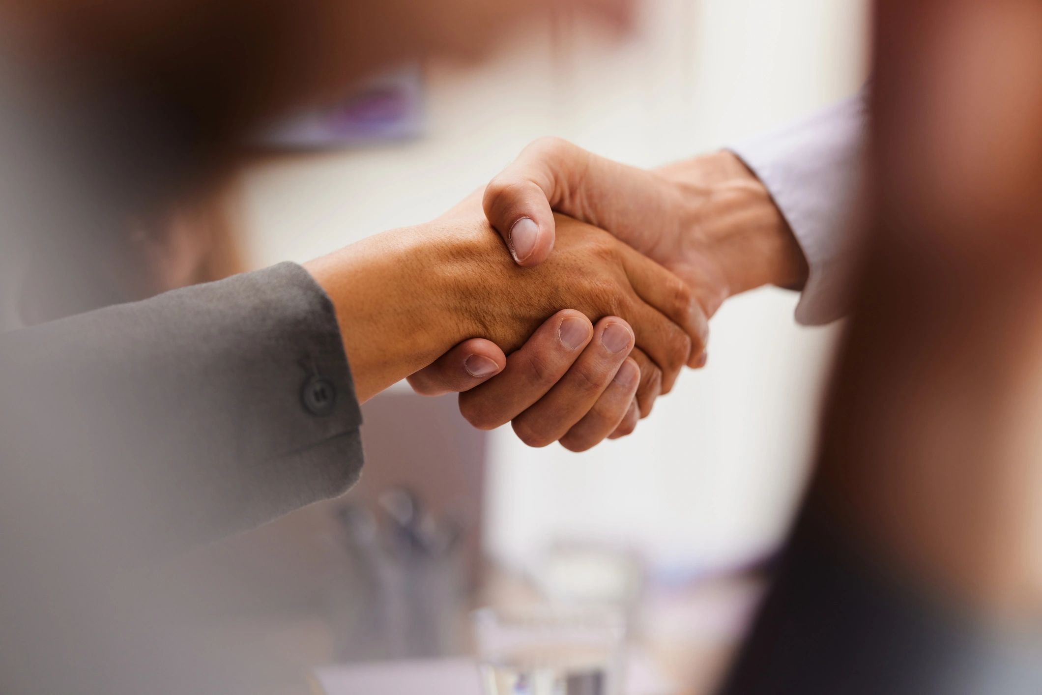 Business colleagues shaking hands after reaching an agreement