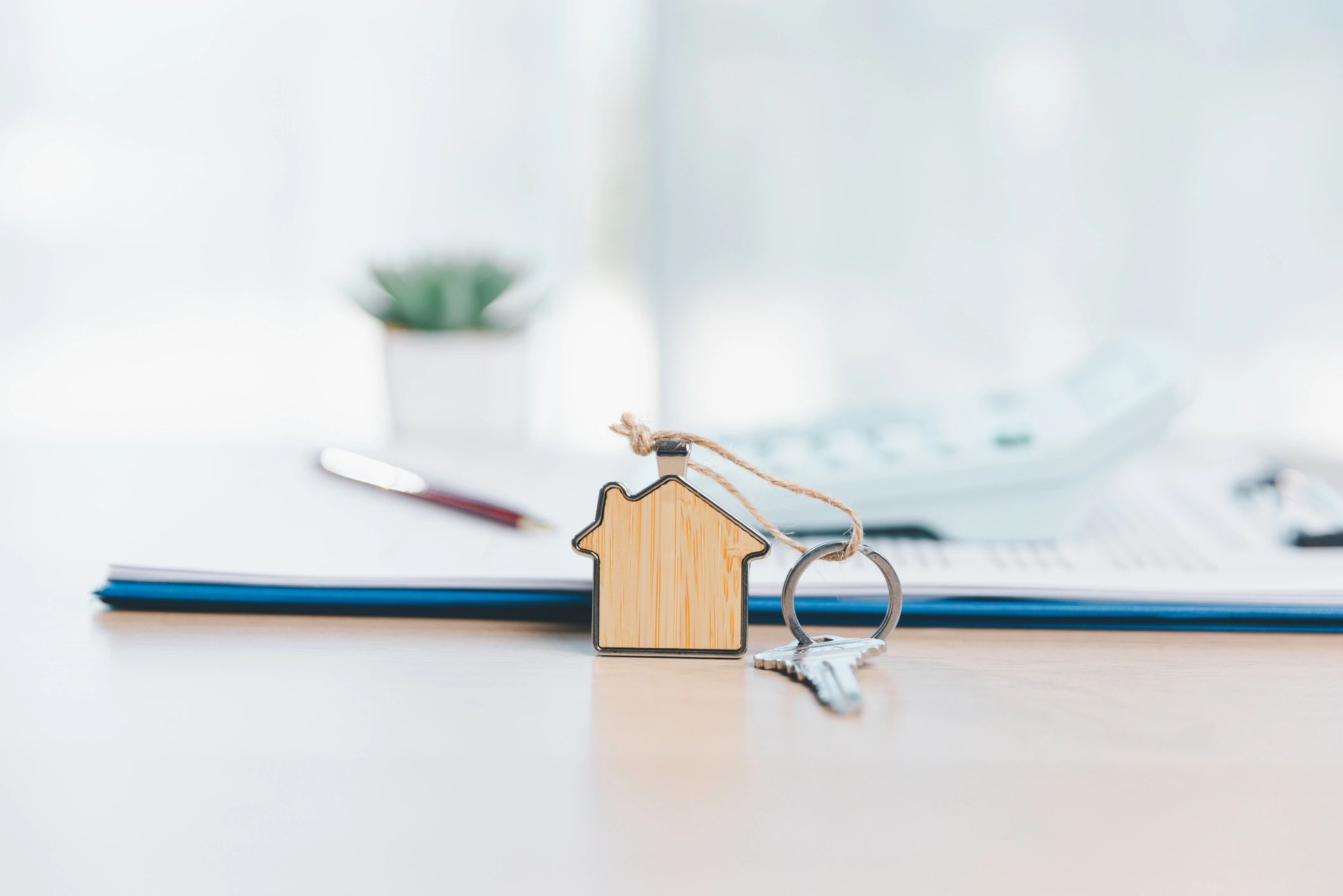 House key and contract representing title insurance and settlement paperwork